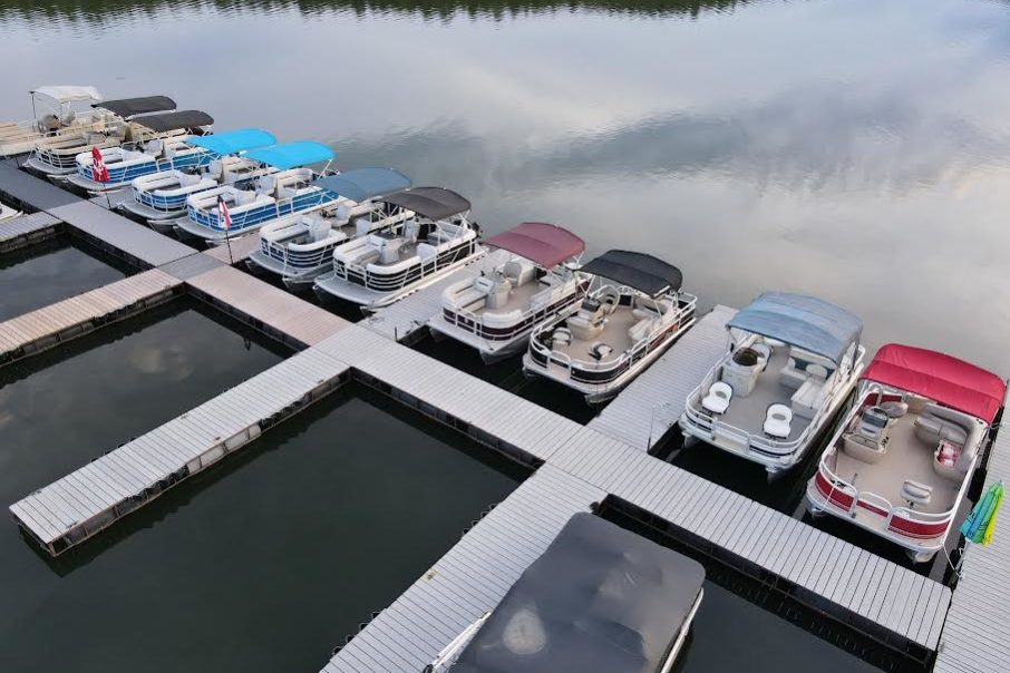 Overhead view of multiple boats docked available for rent.